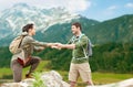 Happy couple with backpacks traveling in highlands Royalty Free Stock Photo