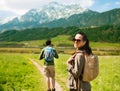 Happy couple with backpacks traveling in highlands Royalty Free Stock Photo