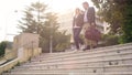 Happy couple with bags leaving hotel and going downstairs, vacation travel Royalty Free Stock Photo