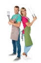 Happy couple with barbecue utensils on white