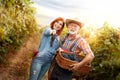 Happy couple with baskets full of grapes Royalty Free Stock Photo