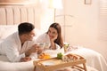 Happy couple in bathrobes having breakfast at home Royalty Free Stock Photo