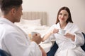 Happy couple in bathrobes having breakfast at home Royalty Free Stock Photo