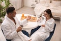 Happy couple in bathrobes having breakfast Royalty Free Stock Photo