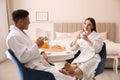 Happy couple in bathrobes having breakfast Royalty Free Stock Photo