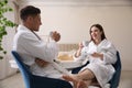 Happy couple in bathrobes having breakfast at home Royalty Free Stock Photo