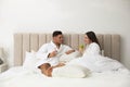 Happy couple in bathrobes resting on bed at home Royalty Free Stock Photo