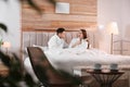 Happy couple in bathrobes resting on bed at home Royalty Free Stock Photo