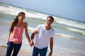 Happy couple, beach and holding hands with love for bonding, embrace or outdoor holiday in nature. Young man and woman Royalty Free Stock Photo