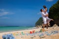 Happy Couple, at Beach, Holds Hands, Sea. Travel at Bali. Royalty Free Stock Photo