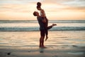 Happy couple at beach hug and love celebration on romantic sunset tropical ocean water hawaii luxury vacation travel or Royalty Free Stock Photo