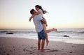 Happy couple at beach lift and hug to celebrate love on romantic sunset tropical ocean water Hawaii luxury vacation Royalty Free Stock Photo