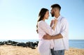 Happy couple on beach near sea. Honeymoon trip Royalty Free Stock Photo