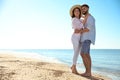 Happy couple on beach near sea. Honeymoon trip Royalty Free Stock Photo