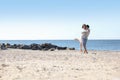 Happy couple on beach near sea. Honeymoon trip Royalty Free Stock Photo