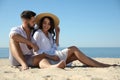 Happy couple on beach near sea. Honeymoon trip Royalty Free Stock Photo