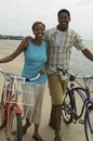 Happy Couple With Bicycles On Beach Royalty Free Stock Photo