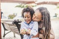 Happy couple black african skin people mother and son young together have fun and enjoy the outdoor leisure activity in the city