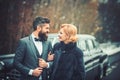 Happy couple at black vintage retro car. Friends going on road trip travel on winter day Royalty Free Stock Photo