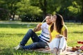 Happy couple blowing soap bubbles in park on spring day Royalty Free Stock Photo