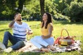 Happy couple blowing soap bubbles in park on spring day Royalty Free Stock Photo