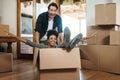 Happy couple, box and real estate in new home or property for renovation and investment together. Excited interracial Royalty Free Stock Photo