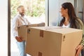 Happy couple, boxes and moving in new home, property or real estate with cardboard box indoors. Man, woman and smile in Royalty Free Stock Photo