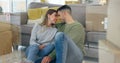Happy couple, boxes and new home at sofa for dream house, living room or property. Man, woman and forehead embrace at Royalty Free Stock Photo