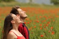 Happy couple breathing fresh air in a red field Royalty Free Stock Photo