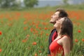Happy couple breathing fresh air on a poppy field Royalty Free Stock Photo