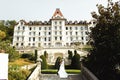 Happy couple bride and groom hugging on stairs in front of luxury hotel Royalty Free Stock Photo