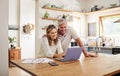 Happy couple budget, laptop finance and tax while planning investment, loan and paperwork bills in home kitchen. Mature Royalty Free Stock Photo