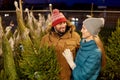Happy couple buying christmas tree at market Royalty Free Stock Photo