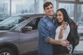 Happy couple buying new car at dealership salon Royalty Free Stock Photo