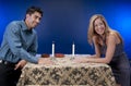 Happy couple at candlelit table