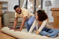 Happy couple with carpet moving to new home