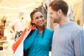 Happy Couple Carrying Bags In Shopping Mall Royalty Free Stock Photo