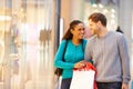 Happy Couple Carrying Bags In Shopping Mall Royalty Free Stock Photo