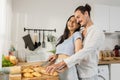 Happy couple caucasian have fun making breakfast in kitchen. Love together. Husband and wife embracing cutting bread enjoy cooking Royalty Free Stock Photo