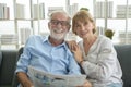 Happy Couple Caucasian senior are relaxing , reading newspaper in living room Royalty Free Stock Photo