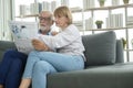 Happy Couple Caucasian senior are relaxing , reading newspaper in living room Royalty Free Stock Photo