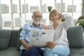 Happy Couple Caucasian senior are relaxing , reading newspaper in living room Royalty Free Stock Photo