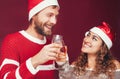 Happy couple celebrating Christmas holidays - Young people having fun drinking champagne and laughing during traditional event Royalty Free Stock Photo