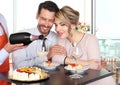 Happy couple celebrating with wine and cake Royalty Free Stock Photo