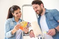 Couple holding paint swatches choosing colors for painting new h Royalty Free Stock Photo