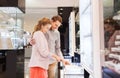 Happy couple choosing engagement ring in mall Royalty Free Stock Photo