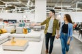 Happy couple choosing furniture in store