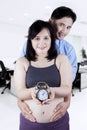 Happy couple with clock in hands Royalty Free Stock Photo