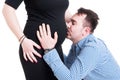 Happy couple concept with husband kissing his pregnant wife bell Royalty Free Stock Photo