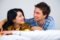 Happy couple conversation in bed Royalty Free Stock Photo